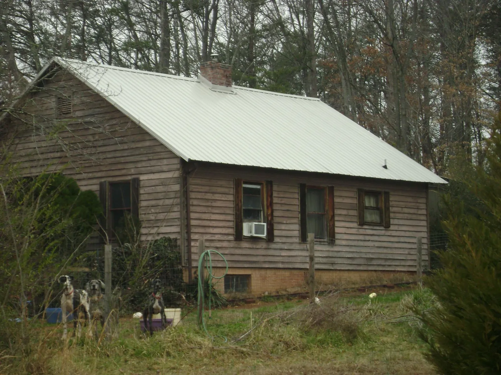 White metal roof on an old wood sided farmhouse, from a Metal Roof Installation job in Flintstone